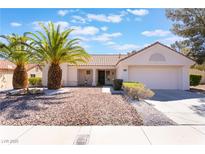 Charming single-story home with desert landscaping and beautiful palm trees in the front yard at 2520 Springridge Dr, Las Vegas, NV 89134