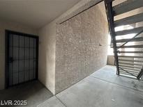 View of the front door with black security gate, leading to outdoor stairs and walkway at 2606 S Durango Dr # 172, Las Vegas, NV 89117