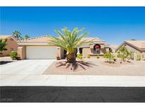Charming single-story home featuring a desert landscape, mature palm tree, and a neutral color palette at 2705 Tumble Brook Dr, Las Vegas, NV 89134