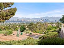 Striking city views from this hillside home in Las Vegas with mature trees and a lovely golf course at 2742 Darby Falls Dr, Las Vegas, NV 89134