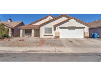 Charming single-story home with stucco siding, desert landscaping, and a two-car garage at 2753 Trickling Brook Ct, Las Vegas, NV 89156