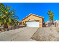 Charming single-story home with well-maintained front yard, desert landscaping, and a two-car garage at 2809 Mountain Violet Ct, Las Vegas, NV 89108