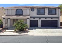 Charming two-story home featuring a two-car garage, front yard landscaping, and a welcoming covered porch at 2873 Cambretto Dr, Henderson, NV 89074