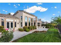 Beautiful home featuring a landscaped backyard, covered patio, and second-story balcony at 2933 Red Springs Dr, Las Vegas, NV 89135