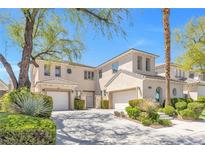Stunning stucco home featuring a well-manicured lawn, two-car garage, and beautiful desert landscaping at 2933 Red Springs Dr, Las Vegas, NV 89135