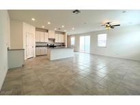 Spacious living room with tile flooring, modern ceiling fan, and lots of natural light at 2970 Saltillo Ln, Las Vegas, NV 89121