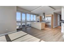 Bright kitchen with stainless steel appliances, center island, and a wall of windows with views at 4471 Dean Martin Dr # 4001, Las Vegas, NV 89103