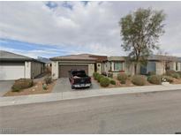 Charming single-story home featuring a two-car garage and inviting desert landscaping in the front yard at 4914 E Beacon Ridge Dr, Pahrump, NV 89061