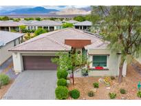 Charming single-story home featuring a desert landscape, two-car garage, and mountain views at 4914 E Beacon Ridge Dr, Pahrump, NV 89061