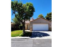 Charming one-story home featuring a two car garage and mature shade tree at 523 Rancho Del Norte Dr, North Las Vegas, NV 89031