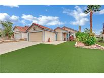 Charming single-story home with manicured lawn and desert landscaping and attached two-car garage at 5512 Kettering Pl, Las Vegas, NV 89107
