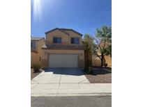 Charming two-story home with a large driveway and a two-car garage on a sunny day at 6525 Bismark Hills St, North Las Vegas, NV 89084
