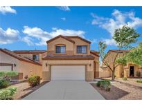 Inviting two-story home featuring a two-car garage and desert landscaping under a beautiful blue sky at 6525 Bismark Hills St, North Las Vegas, NV 89084