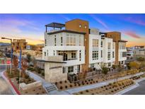 Modern multi-story home with a manicured landscape featuring desert plants and contemporary architectural design at 664 Agate Bridge St, Las Vegas, NV 89138