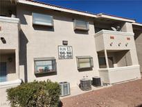 Tan building exterior with visible unit numbers and well-maintained landscaping at 7300 Pirates Cove Rd # 2045, Las Vegas, NV 89145