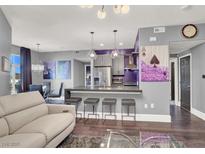 Open-concept living room with modern lighting, sleek furniture, and a stylish kitchen area with bar seating at 9000 S Las Vegas Blvd # 2222, Las Vegas, NV 89123