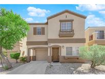 Inviting two-story home features a charming facade and attached garage with a well-manicured front yard at 11164 African Sunset St, Henderson, NV 89052