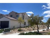 Modern two-story home featuring desert landscaping and attached two-car garage at 11593 Cedar Shore Ave, Las Vegas, NV 89138