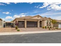 Charming single-story home with a well-manicured front yard and a three-car garage at 1401 Cattail Falls St, Boulder City, NV 89005