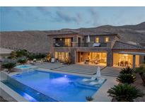 Stunning backyard with a large pool, spa, and outdoor seating areas at 2 Olympia Outlook Dr, Las Vegas, NV 89141