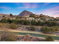 Upscale community homes sit hillside with a mountain backdrop and golf course in foreground at 20 Via Visione # 104, Henderson, NV 89011