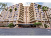 A luxury condo building featuring multi-story living with large balconies and mature tropical landscaping in a secure and welcoming setting at 205 E Harmon Ave # 409, Las Vegas, NV 89169