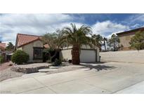 Charming single-story home featuring a desert landscape, concrete driveway, and attached two-car garage at 2701 Brookstone Ct, Las Vegas, NV 89117