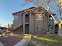 Inviting exterior of a two-story condo, featuring a well-maintained lawn and a private entrance at 2750 S Durango Dr # 1038, Las Vegas, NV 89117