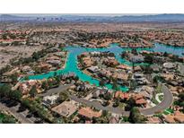 Gorgeous aerial view of lakeside homes in a beautiful planned community with lush landscaping and lake access at 2805 High Sail Ct, Las Vegas, NV 89117
