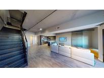 Spacious modern living room with sleek staircase and open-concept kitchen, perfect for entertaining at 353 E Bonneville Ave # 125, Las Vegas, NV 89101