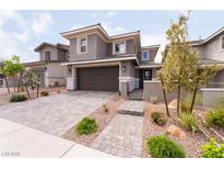 Beautiful two-story home featuring a paved driveway, a two car garage, and professionally landscaped yard at 356 Silva Pl, Henderson, NV 89011
