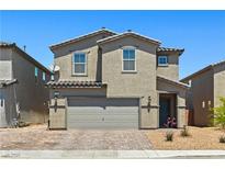 Charming two-story home featuring desert landscaping, neutral color palette, and attached two car garage at 438 Shimmering Sands Ave, North Las Vegas, NV 89031