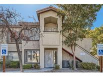 Two-story condo features stucco exterior, front balcony and accessible parking at 4955 Lindell Rd # 130, Las Vegas, NV 89118
