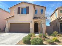 Two-story home with a two-car garage and desert landscaping at 5513 Silent Springs Dr, Las Vegas, NV 89122