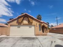 Charming single-story home featuring a two-car garage, terracotta tile roof, and stucco facade at 5536 Cleary Ct, Las Vegas, NV 89108