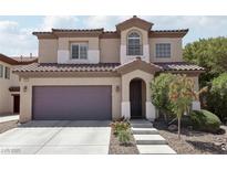 Charming two-story home with a well-manicured lawn, desert landscaping, and attached two car garage at 5655 Danforth Ave, Las Vegas, NV 89141