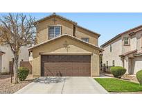 Two-story home with a well-maintained lawn and a two-car garage at 6390 Whispering Clouds Ct, Las Vegas, NV 89141