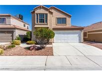 Two-story home with desert landscaping, a two-car garage, and a neutral color scheme at 6428 Yarmouth Dr, Las Vegas, NV 89108