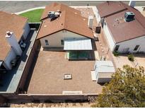 Aerial view of a backyard with gravel landscaping, covered patio, and detached storage shed at 7268 Wichita Ct, Las Vegas, NV 89119