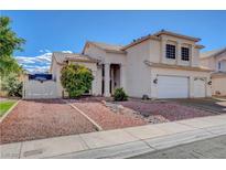 Charming two-story home featuring a three-car garage, rock landscaping, and manicured shrubbery in a suburban setting at 7817 Safari Ln, Las Vegas, NV 89129