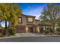 Charming two-story home featuring a three-car garage and beautifully landscaped front yard at 7872 Regency Park St, Las Vegas, NV 89149