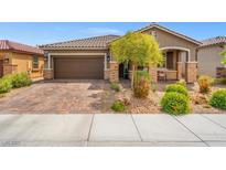 Charming single-story home featuring a well-manicured yard, a two-car garage and stone accents at 8058 Big Skye Ranch St, Las Vegas, NV 89166