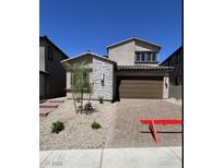 Charming two-story home featuring a two-car garage, stone accents, and low-maintenance landscaping at 84 Via Franello, Henderson, NV 89011