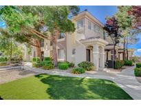 Charming two-story townhome featuring manicured landscaping and inviting front entrances at 9050 W Warm Springs Rd # 1074, Las Vegas, NV 89148