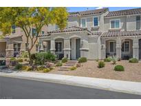 Beautiful townhome featuring a well-manicured lawn and desert landscaping, enhanced by a shade tree at 946 Belton Lake Ave, North Las Vegas, NV 89086