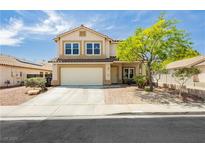 Charming two-story home featuring a well-maintained lawn and an attached two-car garage at 977 Trackers Glen Ave, Henderson, NV 89015