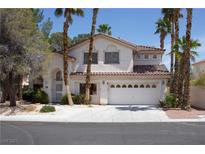 Inviting two-story home features a well-manicured lawn and a spacious two-car garage, enhancing its curb appeal at , Las Vegas, NV 89128