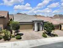 Charming single-story home featuring a well-manicured front yard, stone driveway and a two-car garage at 1063 Upper Springs St, Henderson, NV 89002