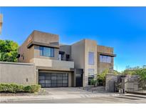 Contemporary two-story home featuring a stylish garage door and modern architectural design at 1181 Calle De Luz, Henderson, NV 89012