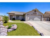 Charming single-story home with a two-car garage, green lawn, and desert landscaping at 190 Channel Dr, Henderson, NV 89002